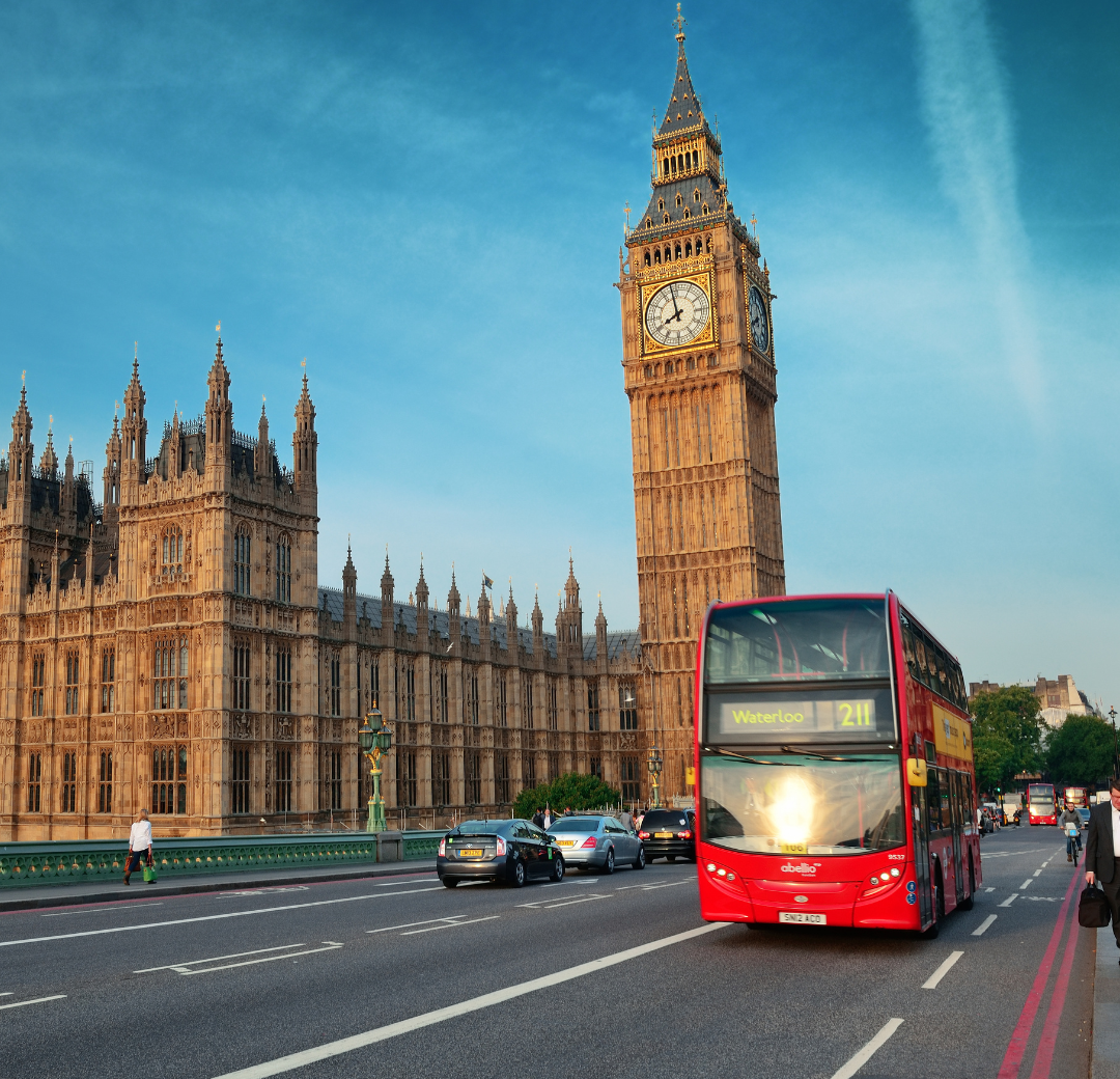 A photo of Big Ben and the Houses of Parliament, with a red London bus in the foreground.