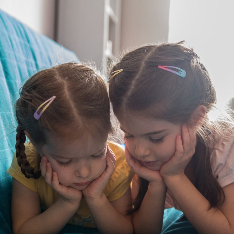 Good school attendance - two little girls looking at a screen