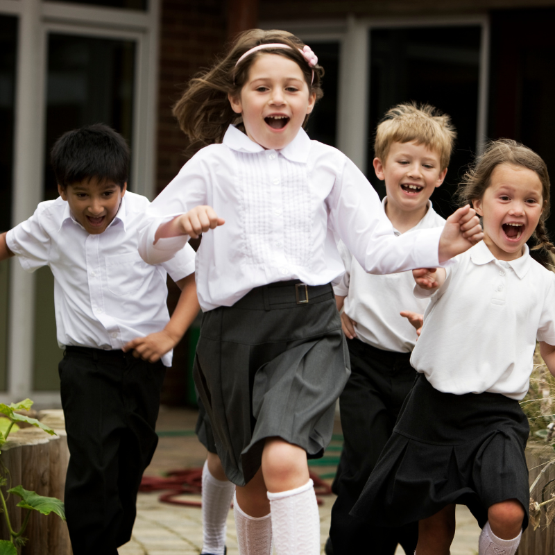 Happy children running towards the camera.