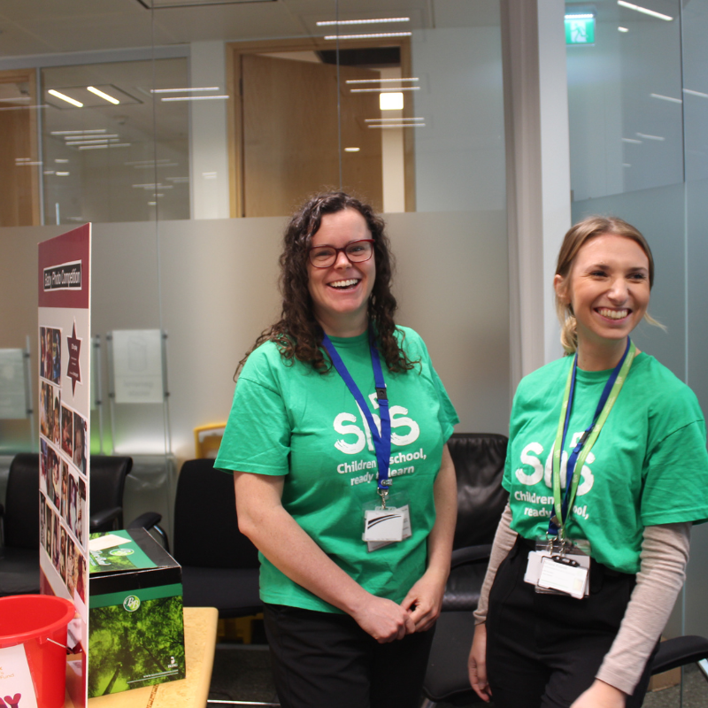 Two people fundraising for School-Home Support